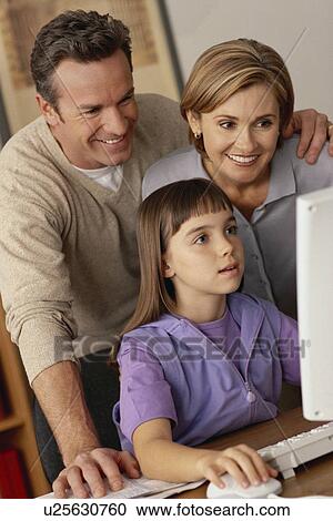 Family looking at computer View Large Photo Image Stock Image - Family looking at computer. Fotosearch