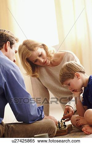 Stock Photography - Family playing chess. Fotosearch