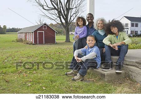 Stock Photo - Family sitting on porch. Fotosearch