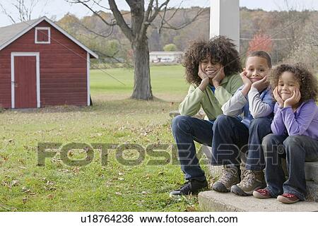 Stock Photograph - Family sitting on porch. Fotosearch