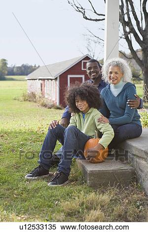 Stock Photography - Family sitting on porch. Fotosearch
