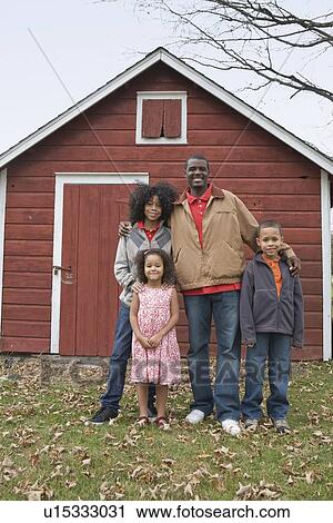 Family standing in front of barn View Large Photo Image Stock Image - Family standing in front of barn. Fotosearch