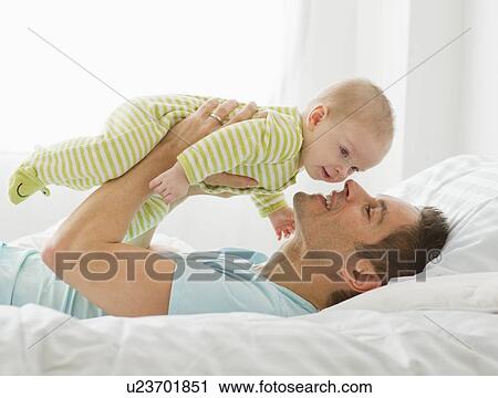 Father and baby playing View Large Photo Image Stock Image - Father and baby playing. Fotosearch