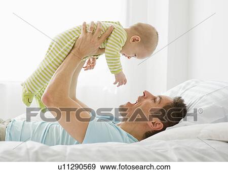 Stock Photo - Father and baby playing. Fotosearch