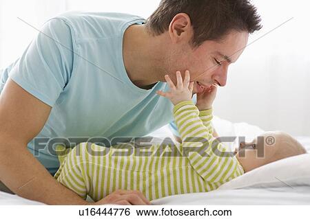 Stock Photograph - Father and baby playing. Fotosearch
