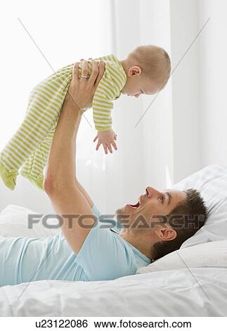 Father and baby playing View Large Photo Image Stock Photograph - Father and baby playing. Fotosearch