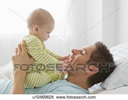 Stock Photography - Father and baby playing. Fotosearch