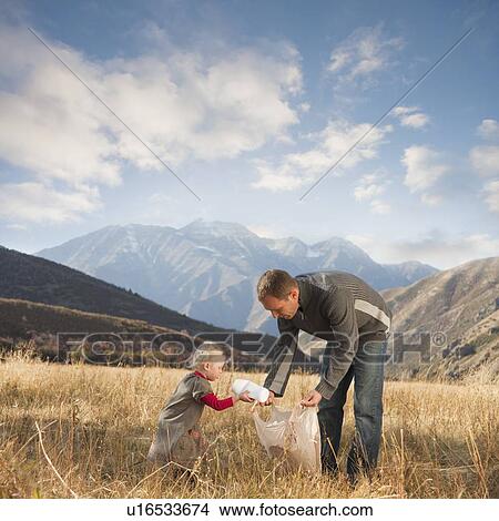 Father and child picking up litter View Large Photo Image Picture - Father and child picking up litter. Fotosearch