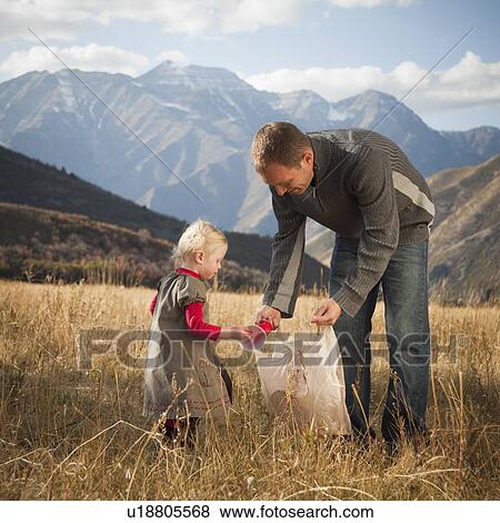Father and child picking up litter View Large Photo Image Stock Photo - Father and child picking up litter. Fotosearch