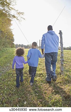 Father and children walking View Large Photo Image Stock Image - Father and children walking. Fotosearch