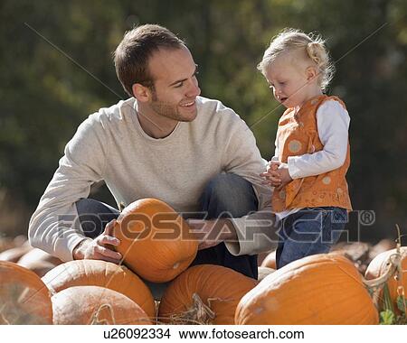 Father and daughter in pumpkin patch View Large Photo Image Picture - Father and daughter in pumpkin patch. Fotosearch