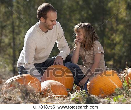 Father and daughter in pumpkin patch View Large Photo Image Stock Photograph - Father and daughter in pumpkin patch. Fotosearch