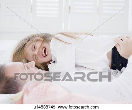 Stock Photography - Father and daughter playing. Fotosearch