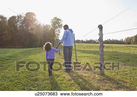 Stock Image - Father and daughter walking. Fotosearch