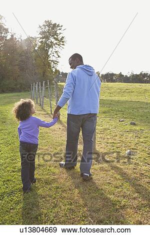 Stock Photo - Father and daughter walking. Fotosearch