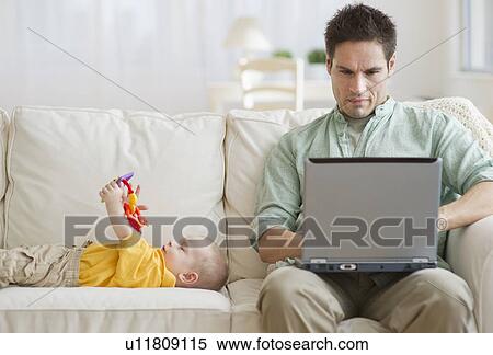 Father and son on couch View Large Photo Image Stock Photography - Father and son on couch. Fotosearch