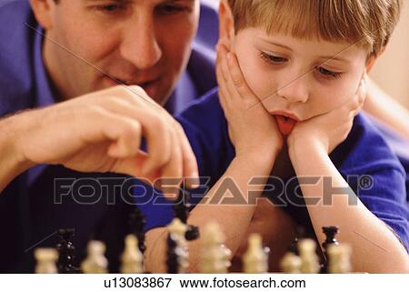 Father and son playing chess View Large Photo Image Stock Photo - Father and son playing chess. Fotosearch