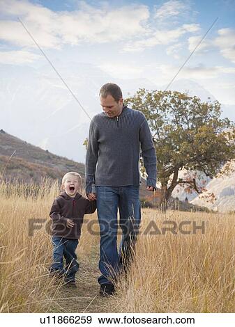 Father and son walking outdoors View Large Photo Image Stock Photo - Father and son walking outdoors. Fotosearch