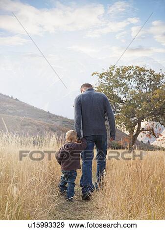 Father and son walking outdoors View Large Photo Image Stock Photo - Father and son walking outdoors. Fotosearch