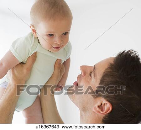Stock Photo - Father holding baby. Fotosearch