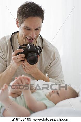 Father taking photograph of baby View Large Photo Image Stock Photography - Father taking photograph of baby. Fotosearch