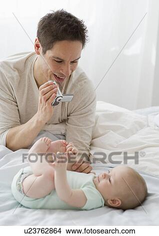 Picture - Father videotaping baby. Fotosearch