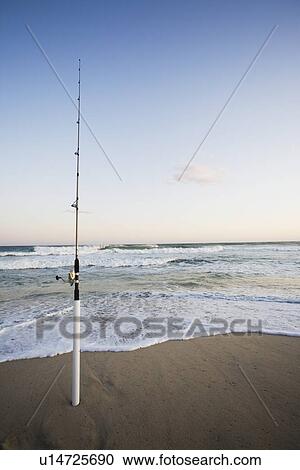 Stock Image - Fishing rod on the beach. Fotosearch