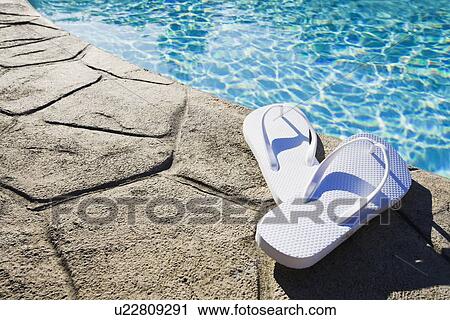 Flip flops by the pool View Large Photo Image Stock Image - Flip flops by the pool. Fotosearch