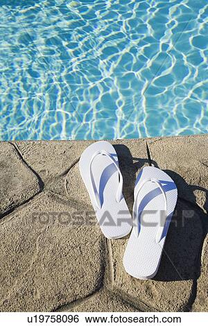 Flip flops by the pool View Large Photo Image Stock Photograph - Flip flops by the pool. Fotosearch