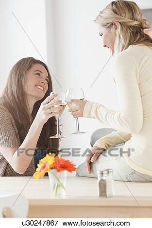 Stock Photo - Friends drinking wine. Fotosearch