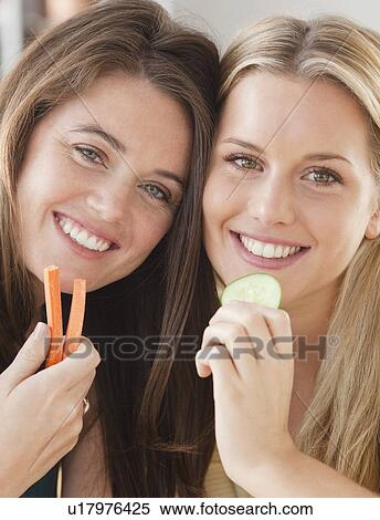 Stock Photography - Friends eating vegetables. Fotosearch