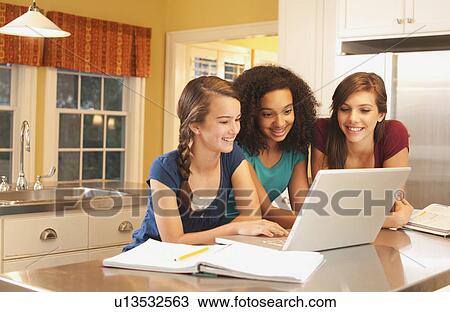 Friends looking at laptop View Large Photo Image Stock Image - Friends looking at laptop. Fotosearch