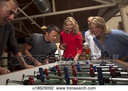 Friends playing foosball View Large Photo Image Stock Image - Friends playing foosball. Fotosearch