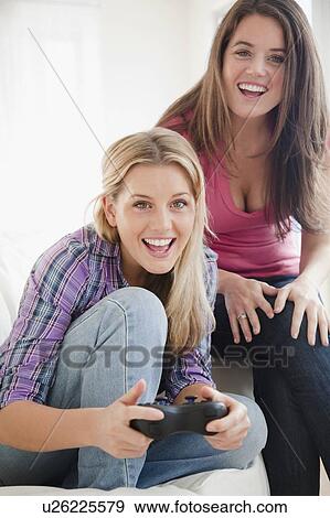Stock Photo - Friends playing video game. Fotosearch