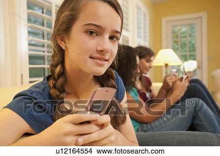 Friends texting View Large Photo Image Picture - Friends texting. Fotosearch
