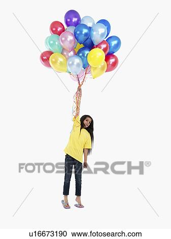 Stock Image - Girl holding balloons. Fotosearch