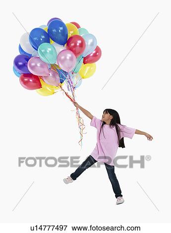 Girl holding balloons View Large Photo Image Stock Photo - Girl holding balloons. Fotosearch