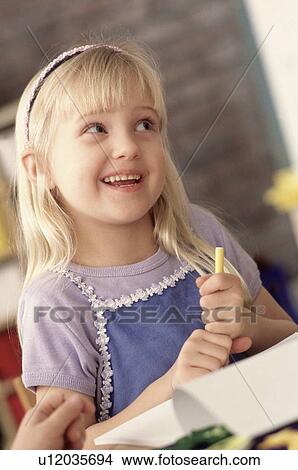 Picture - Girl in classroom. Fotosearch