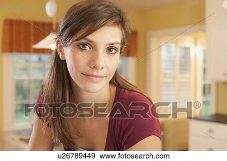 Stock Photo - Girl in kitchen. Fotosearch