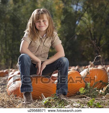 Girl in pumpkin patch View Large Photo Image Stock Image - Girl in pumpkin patch. Fotosearch