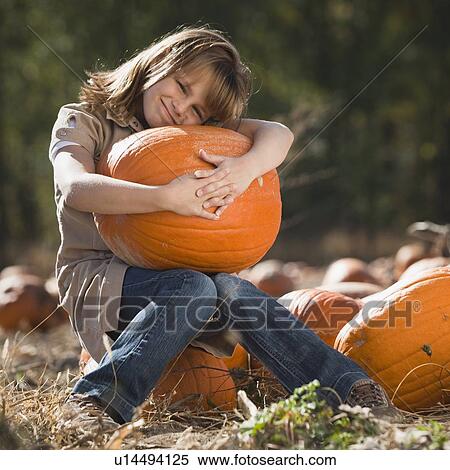 Girl in pumpkin patch View Large Photo Image Stock Photography - Girl in pumpkin patch. Fotosearch