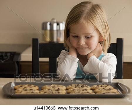 Girl waiting for cookies View Large Photo Image Stock Image - Girl waiting for cookies. Fotosearch