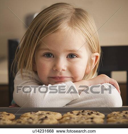 Stock Photo - Girl waiting for cookies. Fotosearch