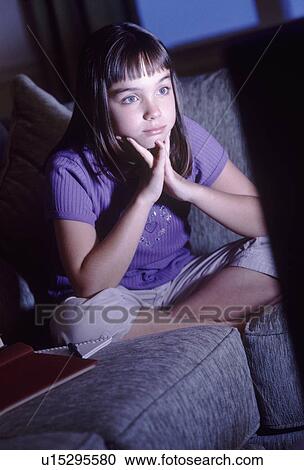Stock Image - Girl watching television. Fotosearch