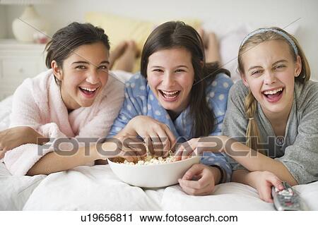 Girls eating popcorn View Large Photo Image Stock Image - Girls eating popcorn. Fotosearch