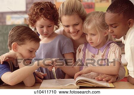 Stock Image - Group of children in classroom. Fotosearch