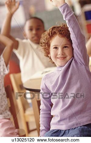 Stock Image - Group of children in classroom. Fotosearch