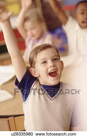 Stock Image - Group of children in classroom. Fotosearch
