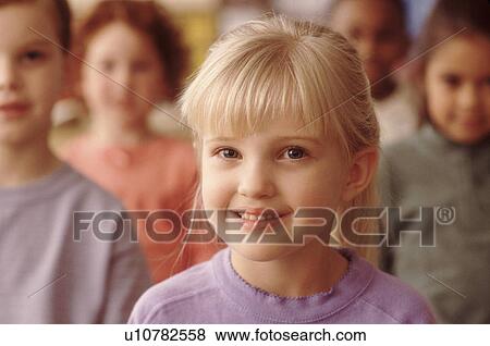 Stock Photo - Group of children in classroom. Fotosearch