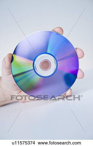 Picture - Hand holding compact disc. Fotosearch